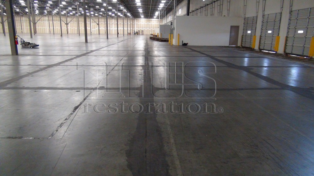When slab curling occurs, the industrial concrete slab is unlevel. Floor Flatness is corrected by grinding the slab level.